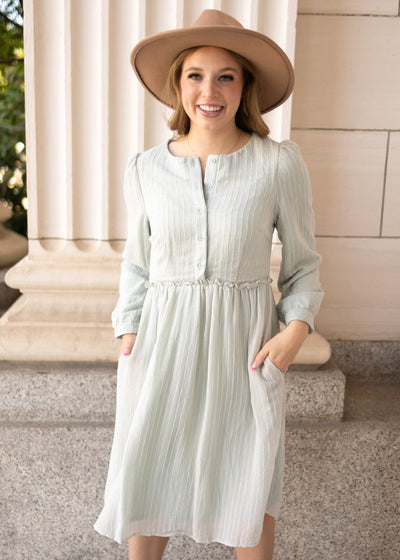 Front view of a long sleeve sage dress
