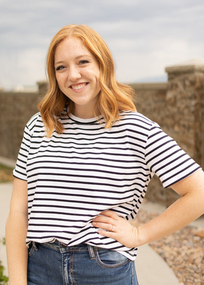 Front view of a short sleeve black top with stirpes