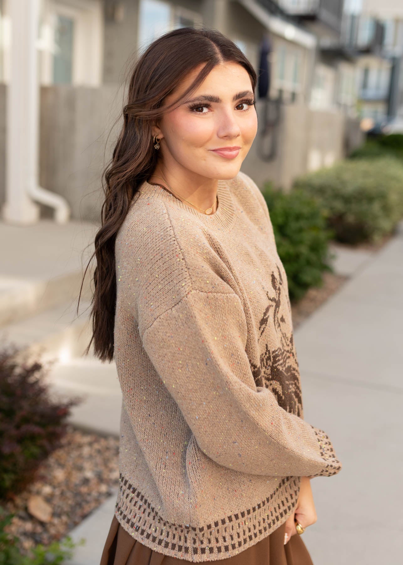 Side view of the tan pattern sweater with horses
