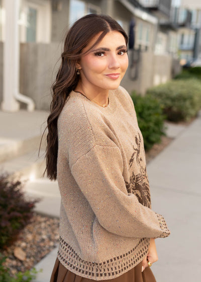 Side view of the tan pattern sweater with horses