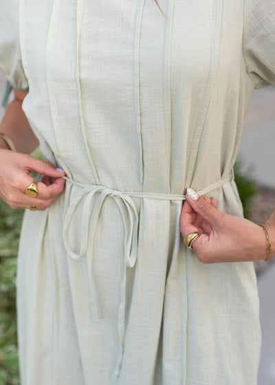 Close up of the waist and tie on the sage dress
