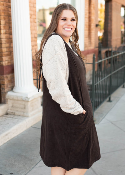 Side view of the brown corduroy overall dress with pockets in plus size