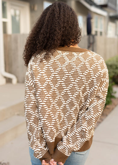 Back view of the white and brown patter weater with brown cuffs