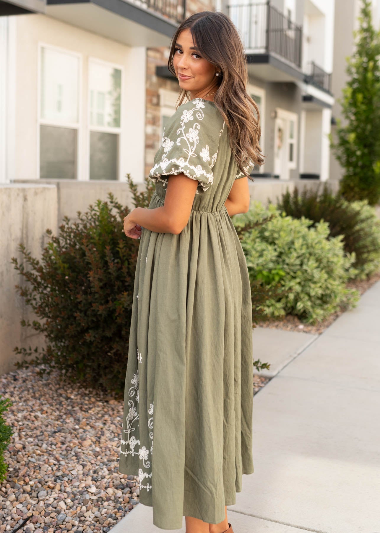 Side view of the modest forest green embroidered dress