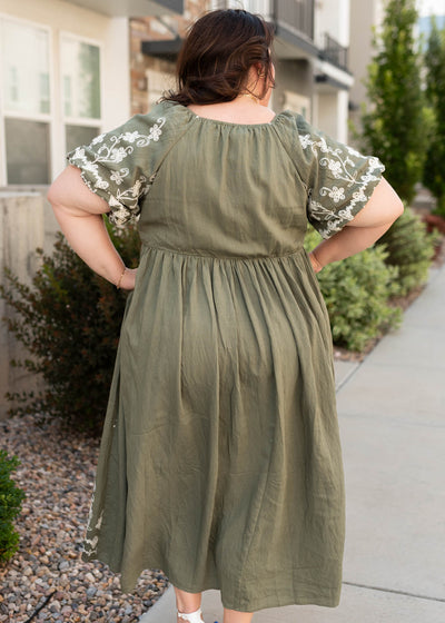 Back view of the forest green embroidered dress in plus size