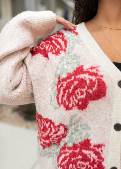 Close up of the flowers of the red floral cardigan