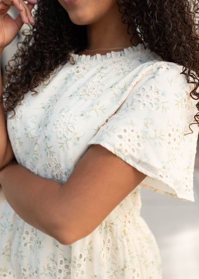 Close up of the print and sleeves on the cream floral dress
