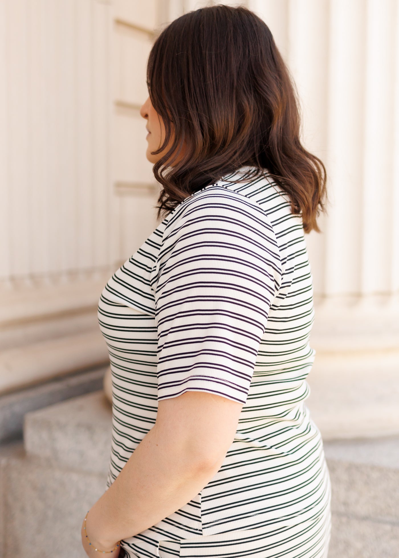 Side view of the plus size black striped top