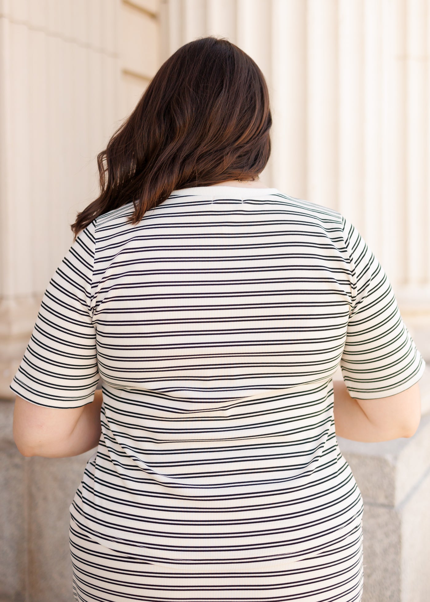 Back view of the black striped top in plus size
