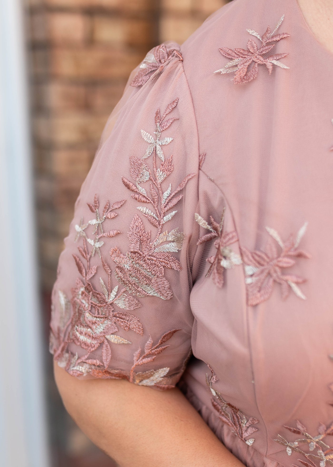 Close up of the sleeve and fabric on the blush floral dress