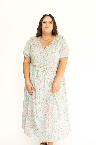 Front view of a plus size light seafoam short sleeve floral dress.