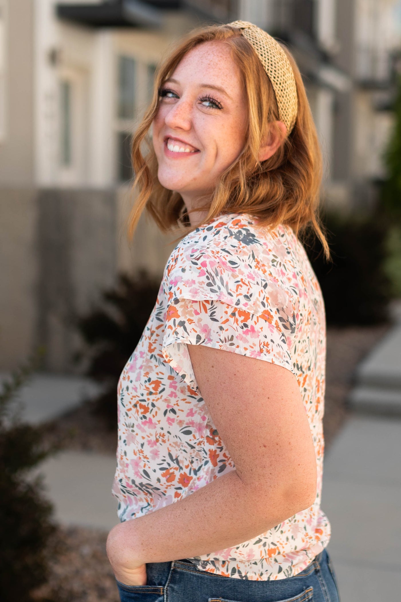 Side view of a ivory floral top