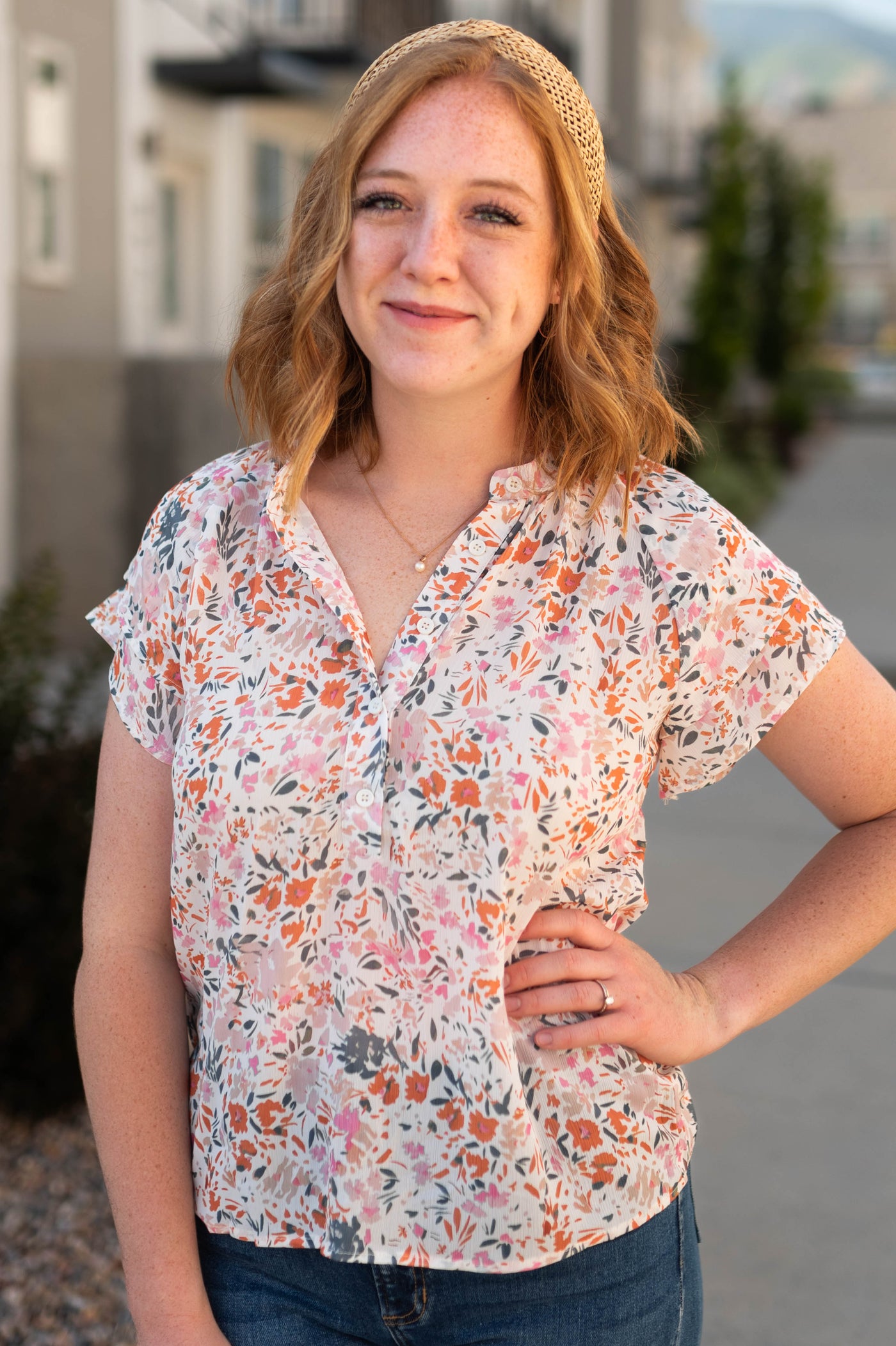 Ivory floral top with buttons at the neck and short sleeves