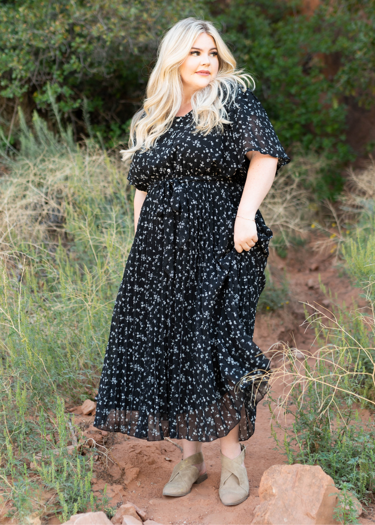 Short sleeve black floral dress with a pleated skirt and tie at the waist