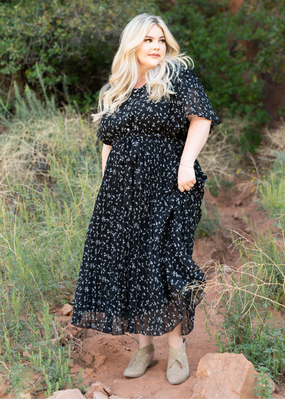 Short sleeve black floral dress with a pleated skirt and tie at the waist