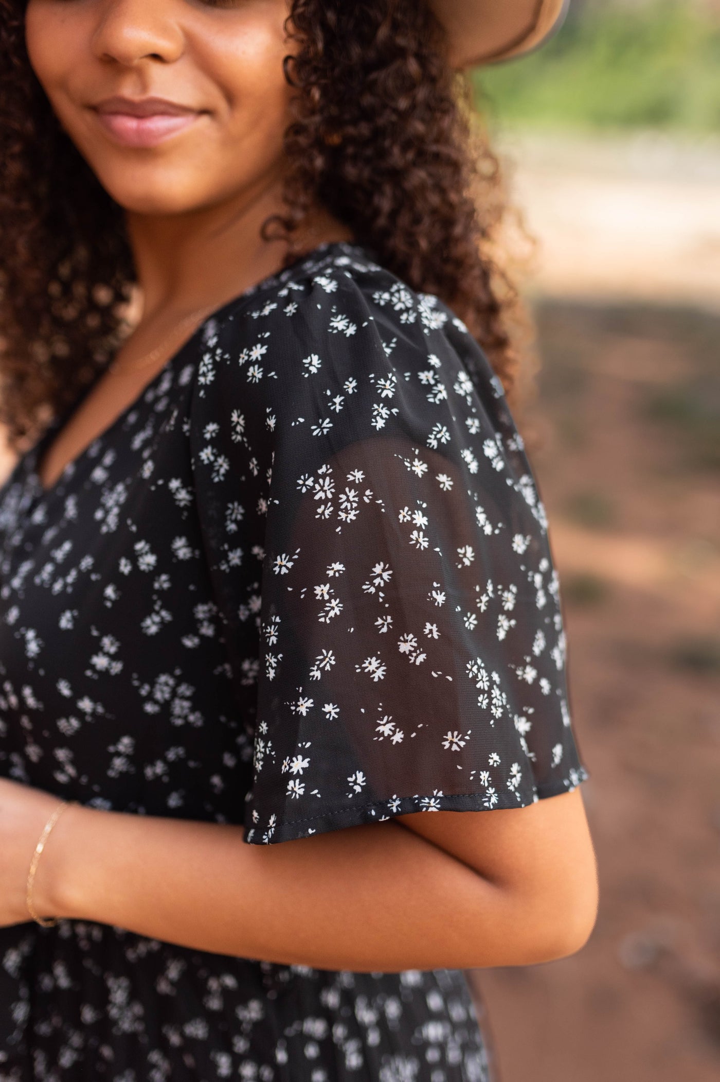 Sleeve of a black floral dress