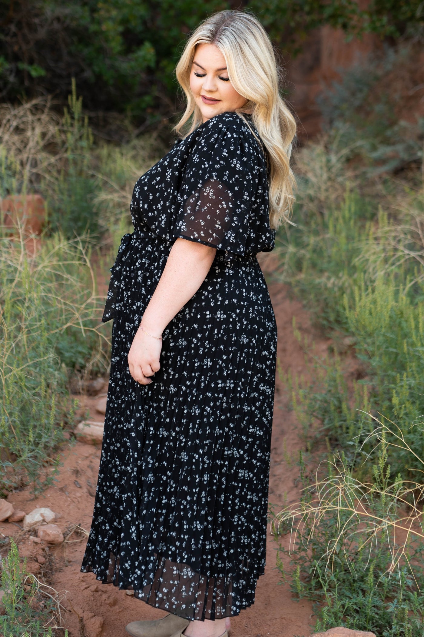Side view of a plus size black floral dress