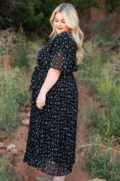 Side view of a plus size black floral dress