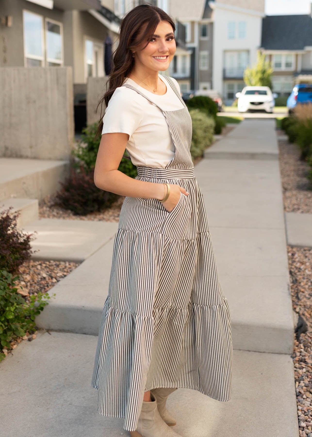 Side view of the modest charcoal stripe overall dress with pockets