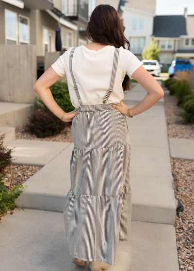 Back view of the charcoal stripe overall dress with adjustable straps in the back.