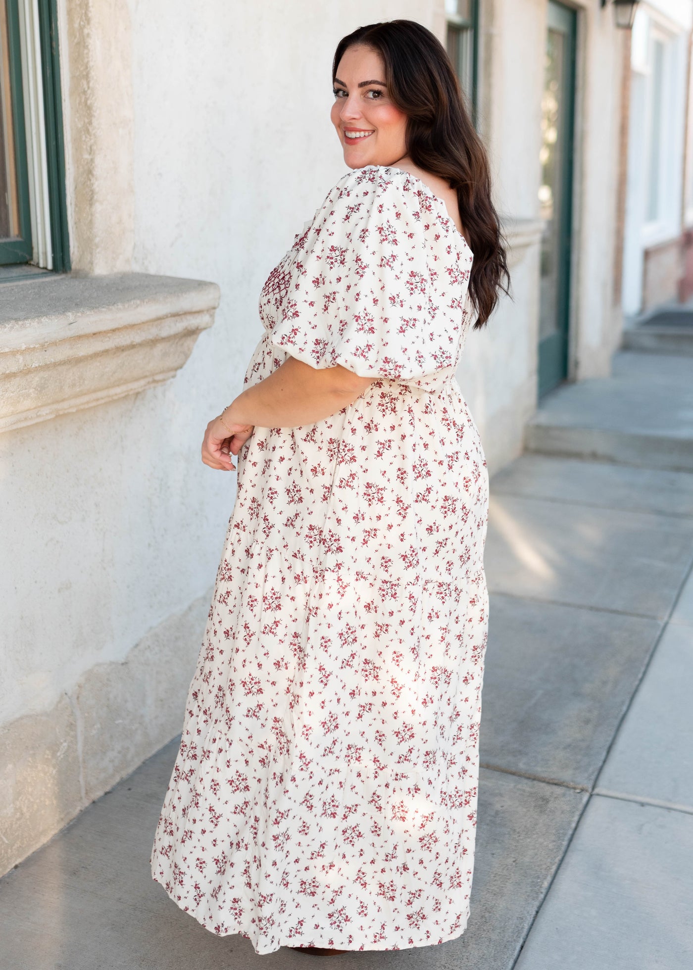 Side view of the plus size beige floral smocked dress