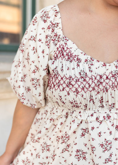 Close up of the smocking and sleeves on the plus size beige floral smocked dress