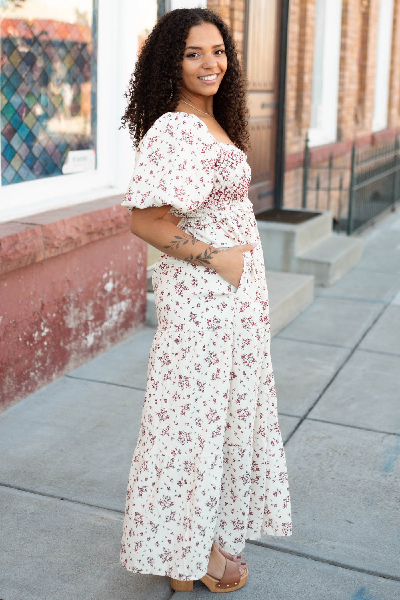 Side view of the modest beige floral smocked dress with pockets