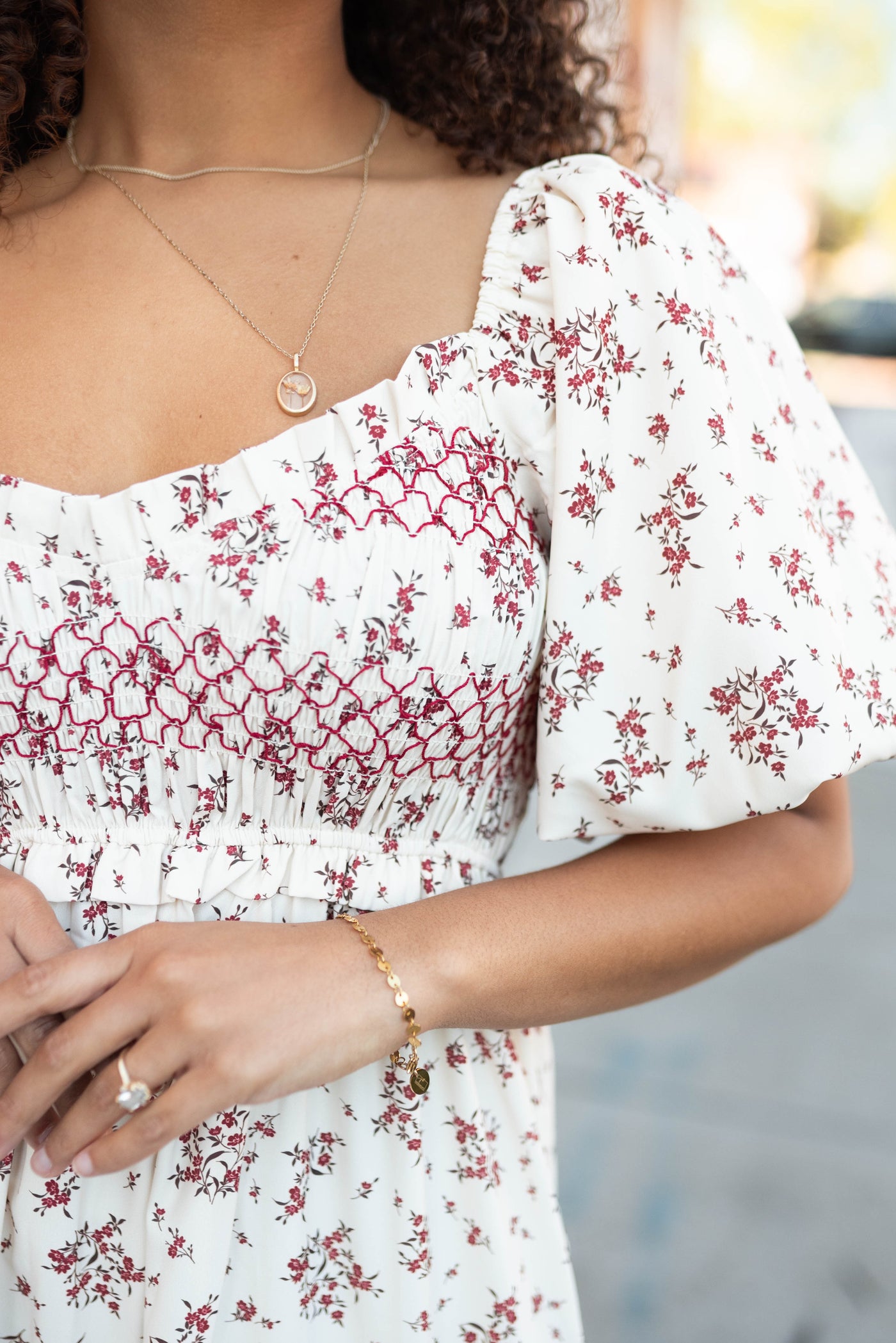 Close up of the smocking and neckline on the beige floral smocked dress
