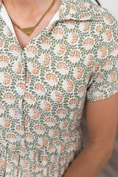 Close up of the buttons and fabric on the green floral collared dress