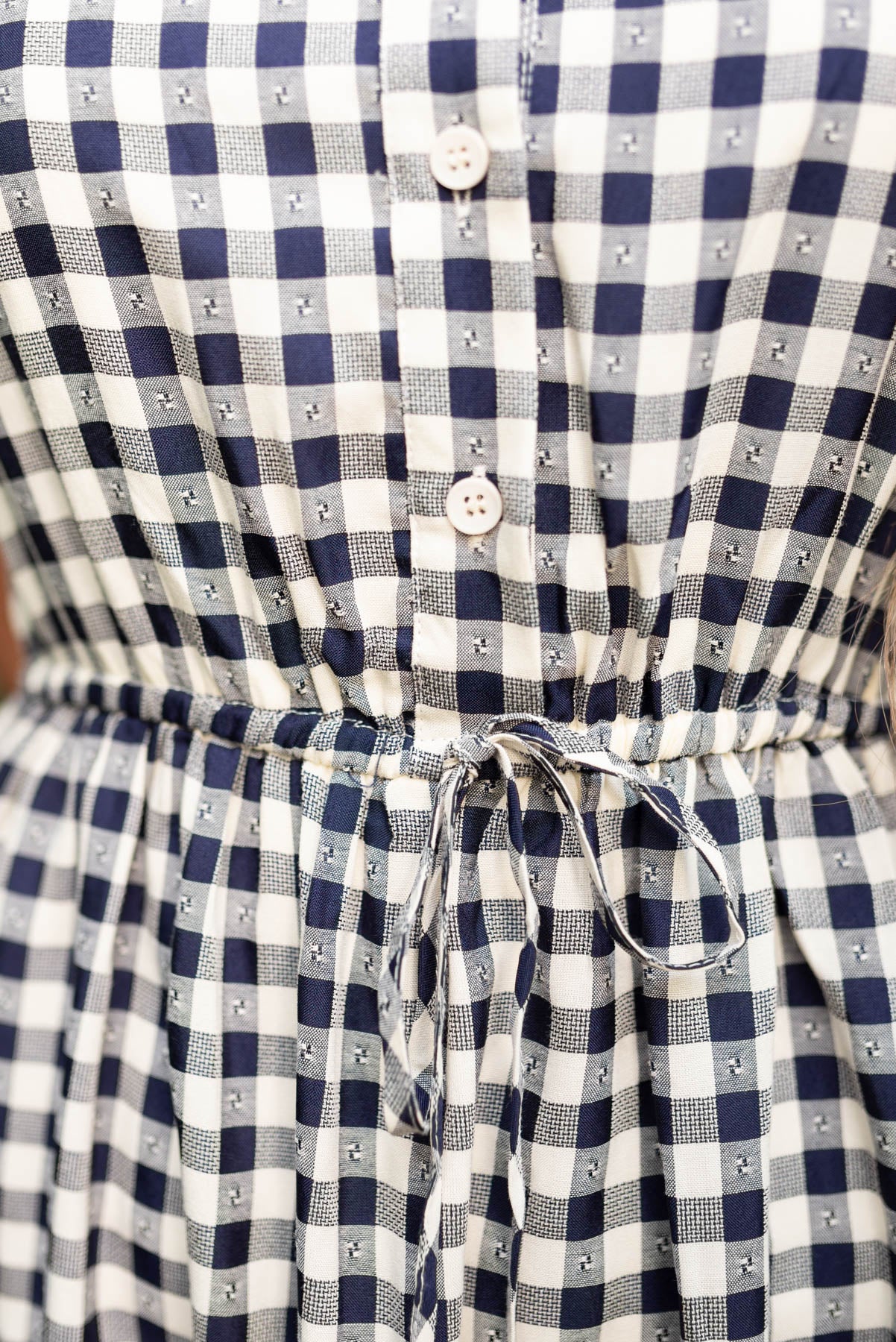 Close up of the waist on the navy tiered dress