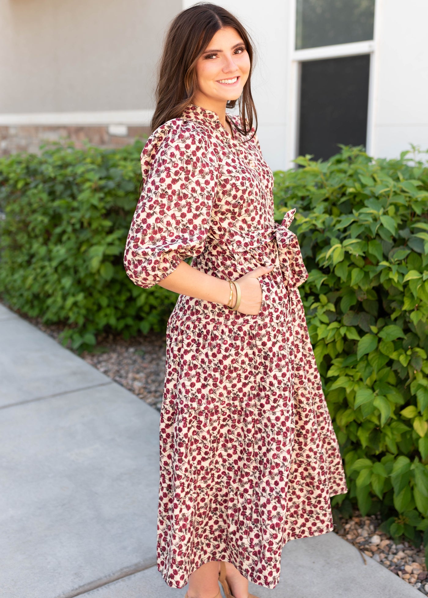 Side view of the burgundy floral dress with pockets