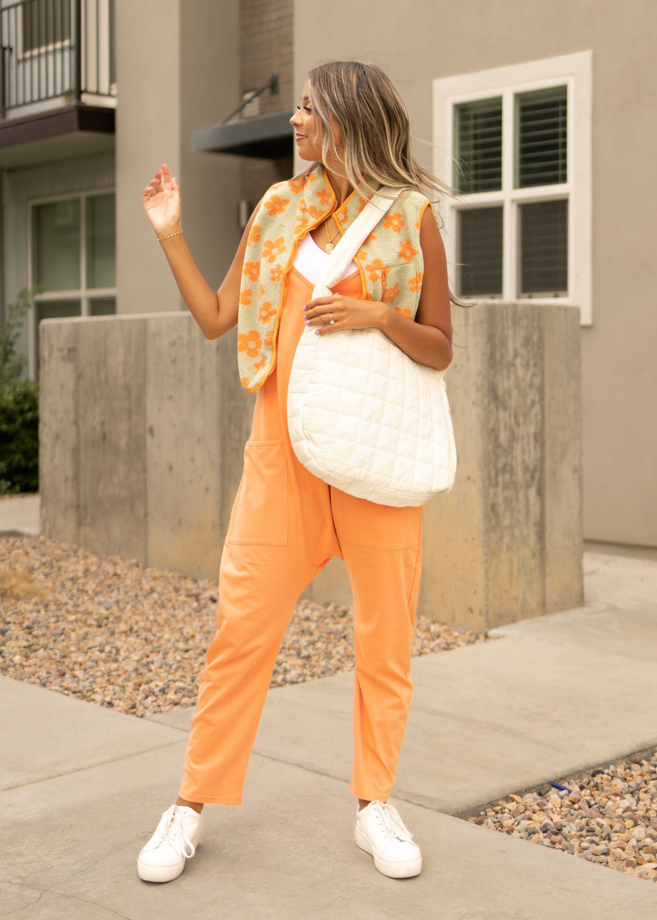 Orange fleece vest with lime green background and orange flowers
