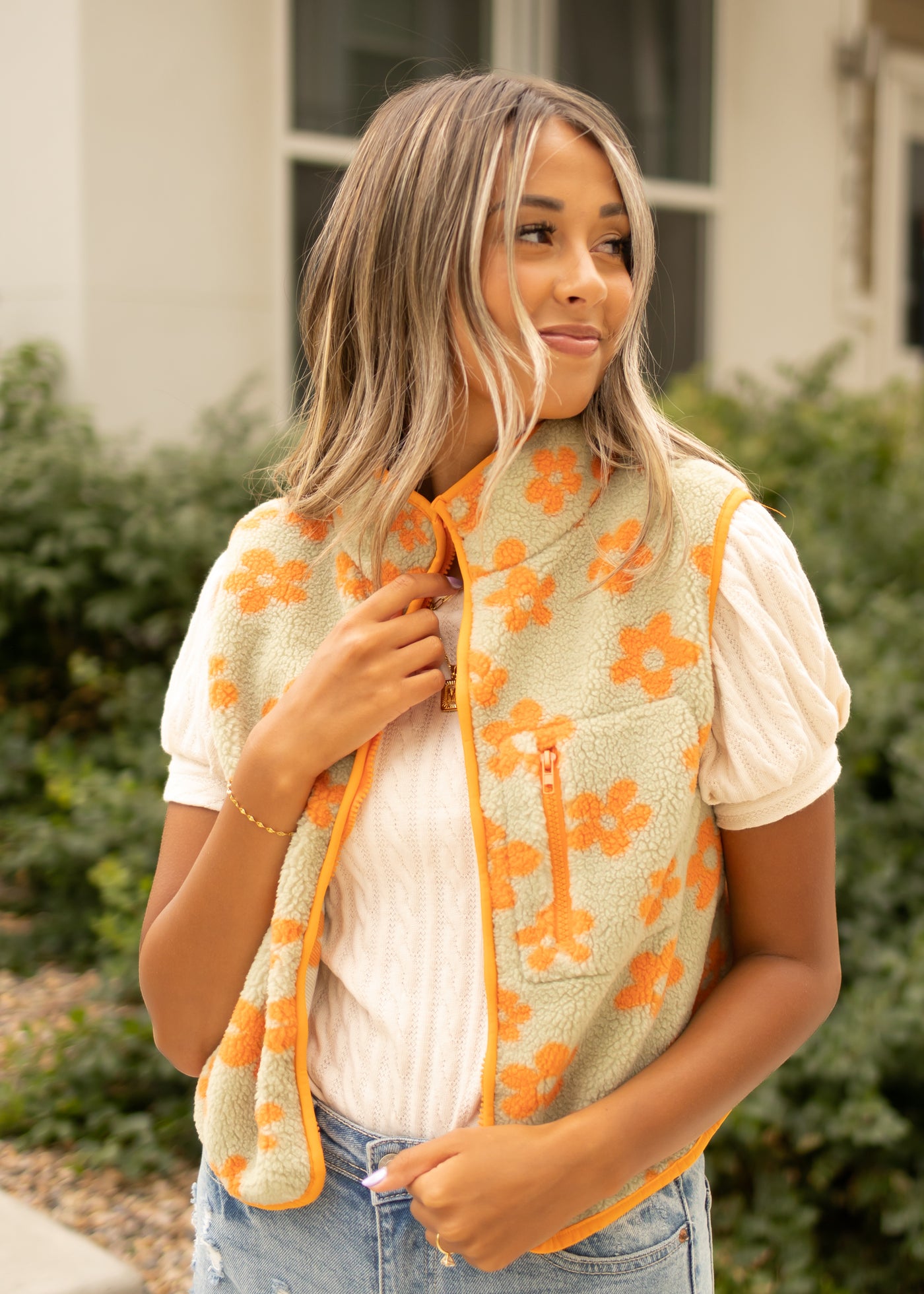 Small orange fleece vest with zipper front pocket