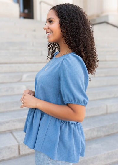 Side view of the blue peplum shirt