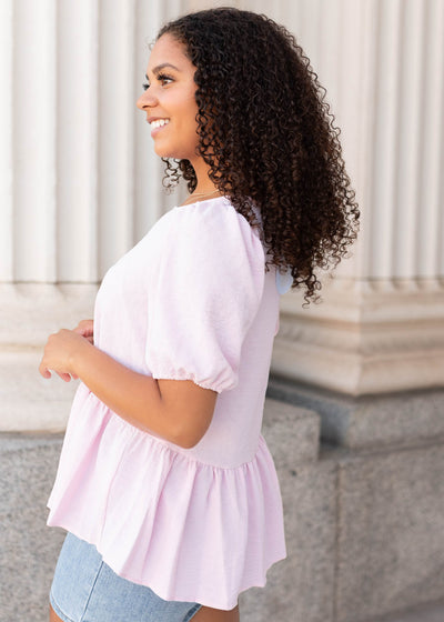 Side view of the pink peplum top