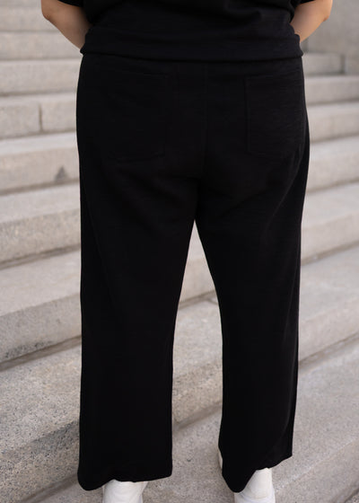 Back view of the plus size black knit pants