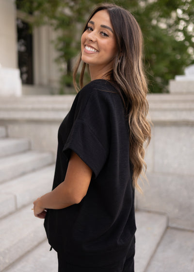 Side view of the lena Lou black knit top with drop sleeve