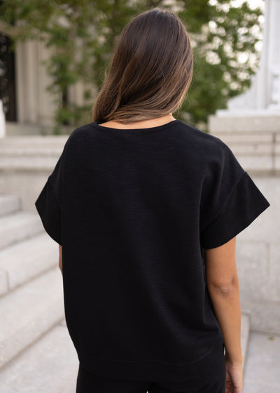 Back view black knit top