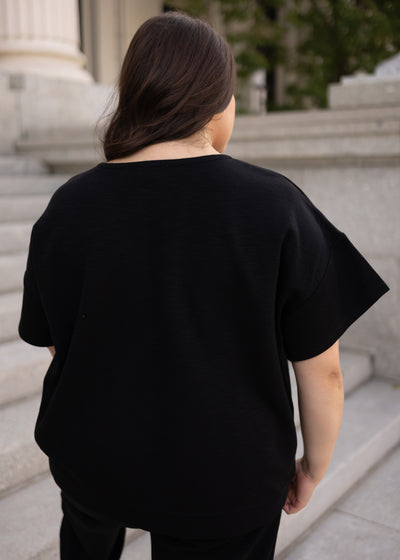 Back view of the black knit top