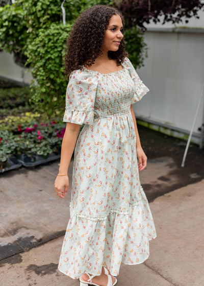 Side view of the mint floral dress with a smocked bodice
