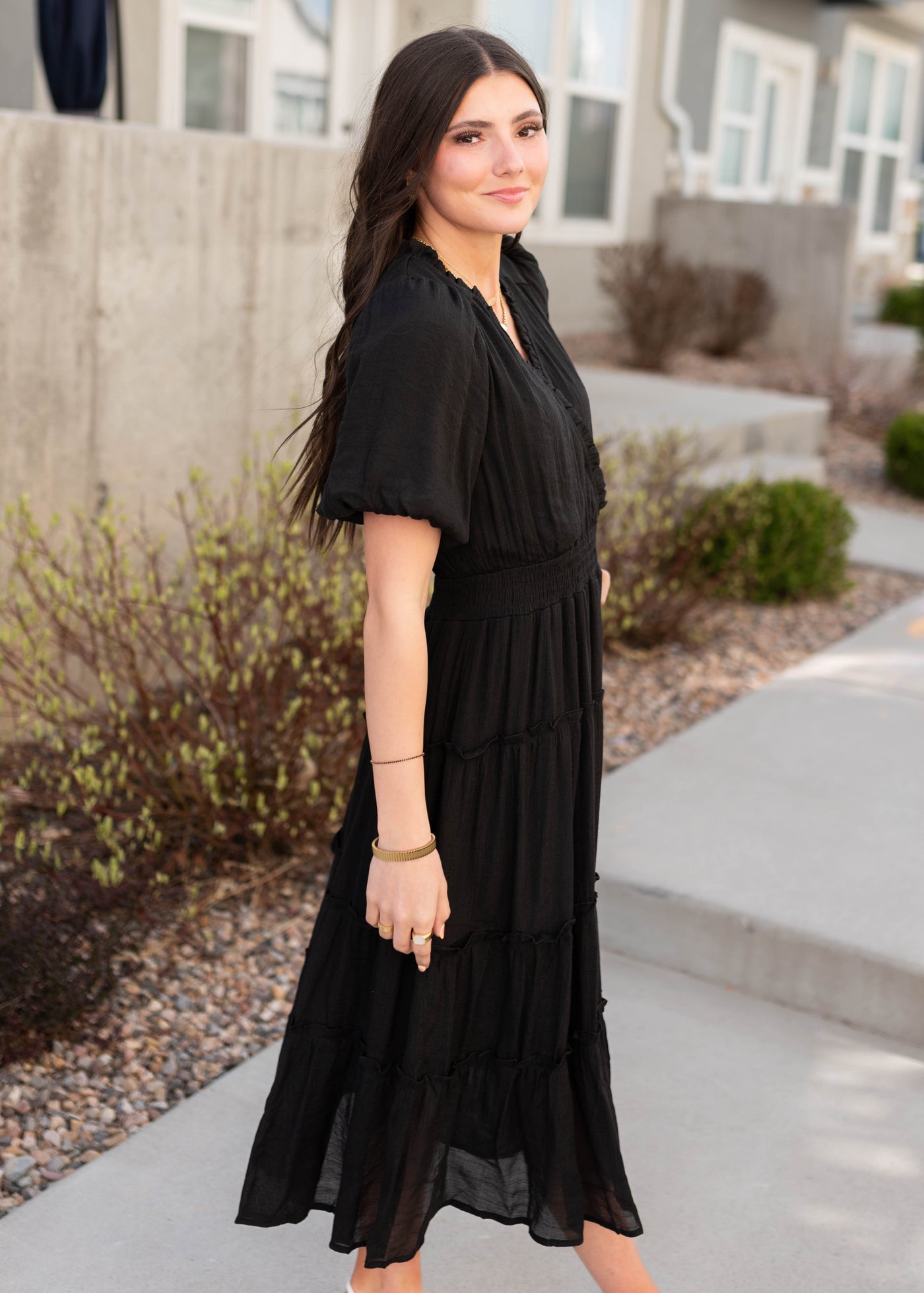 Side view of the black puff sleeve dress