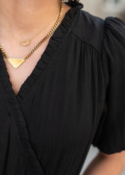 Close up of the bodice on the black puff sleeve dress