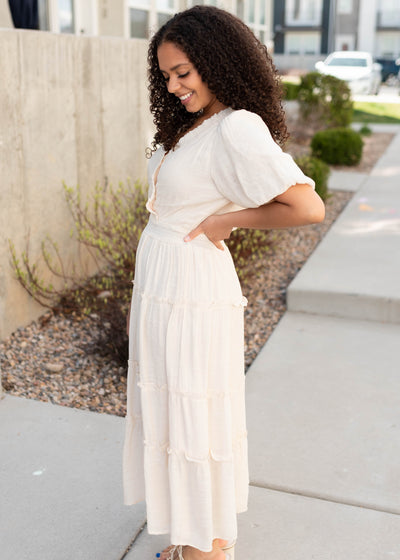 Side view of the natural puffed sleeve dress