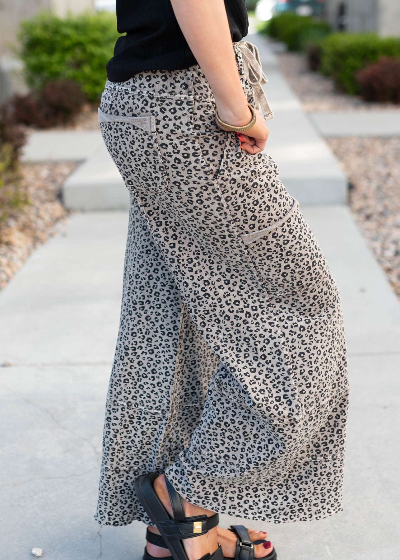 Side view of the ash brown leopard pants