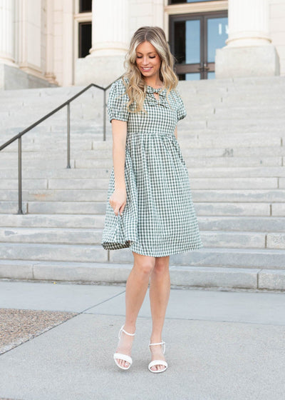 Two bows on the sage gingham bow dress with puff sleeves