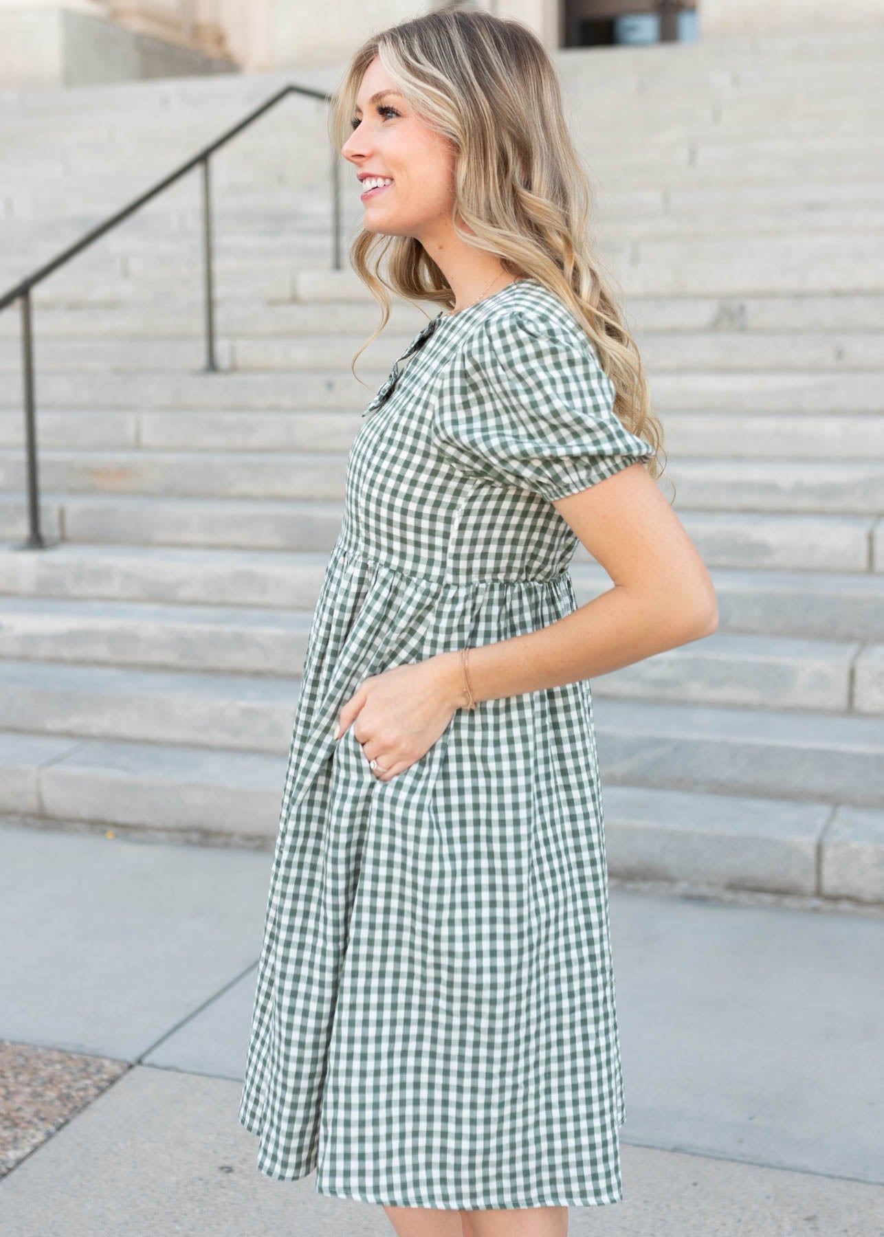Side view of the modest sage gingham bow dress with pockets