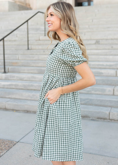 Side view of the modest sage gingham bow dress with pockets