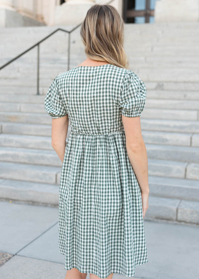 Back view of the sage gingham bow dres with gathering at the waist