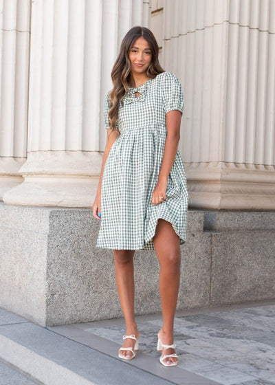 Knee length sage gingham bow dress with short sleeves and gathered waist
