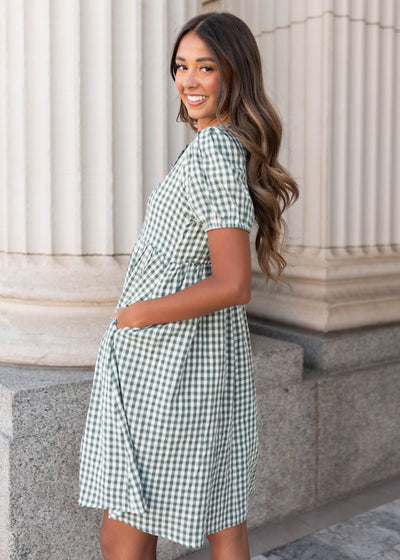 Side view of the modest sage gingham bow dress with pockets